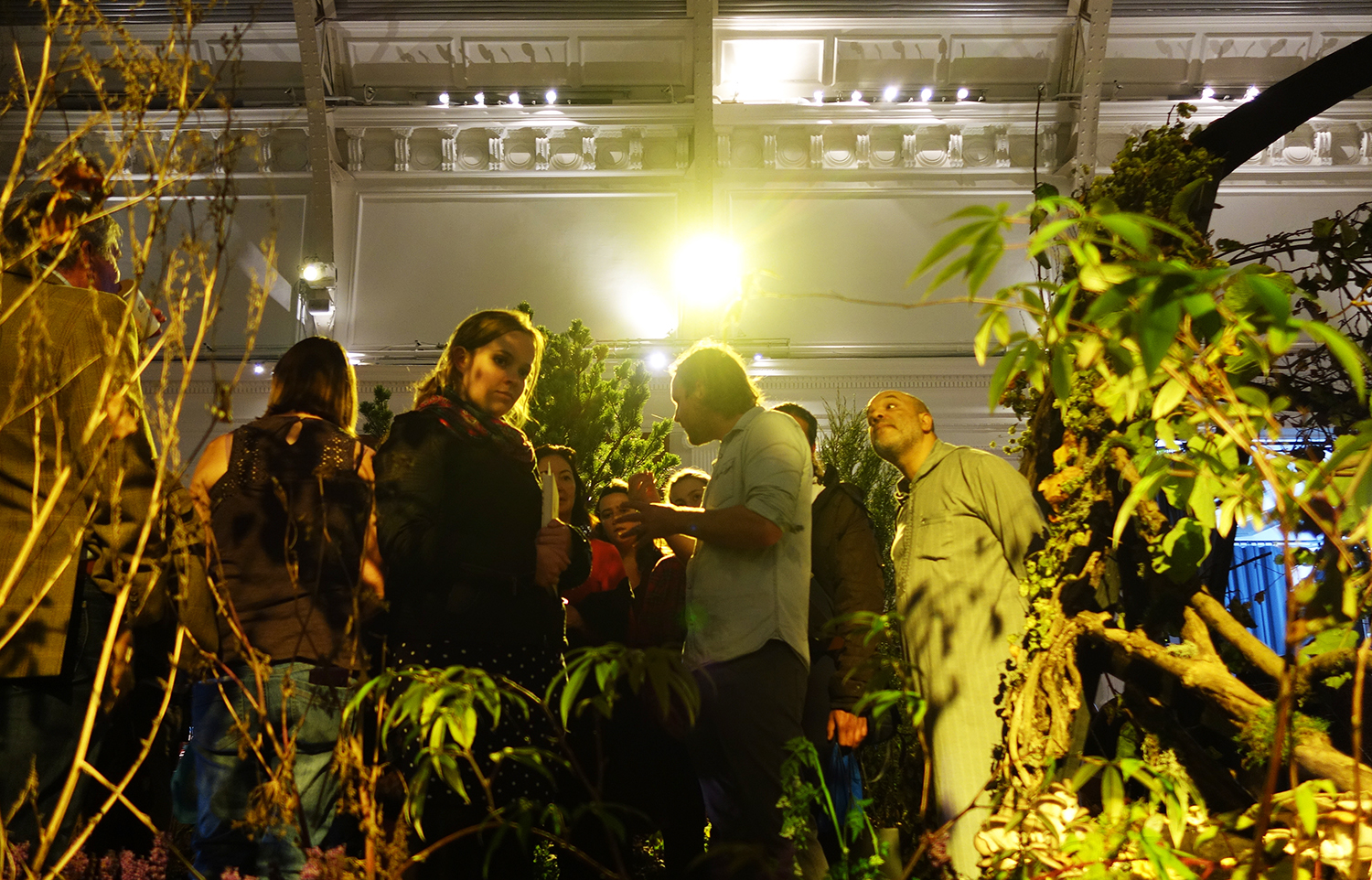 The crowd gathers within the food forest at Lindley Hall