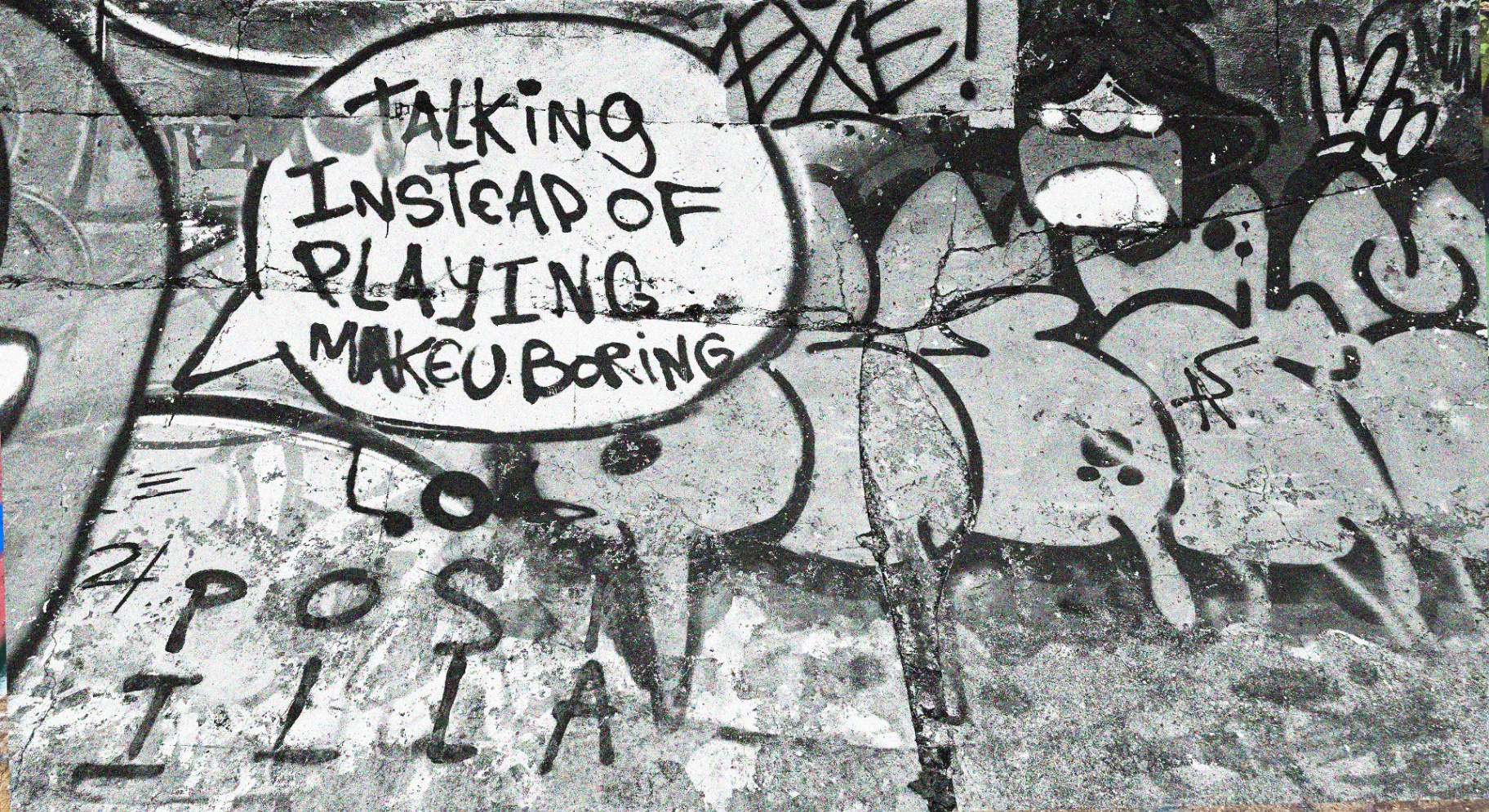 Graffiti reading 'Talking instead of playing makes u boring'