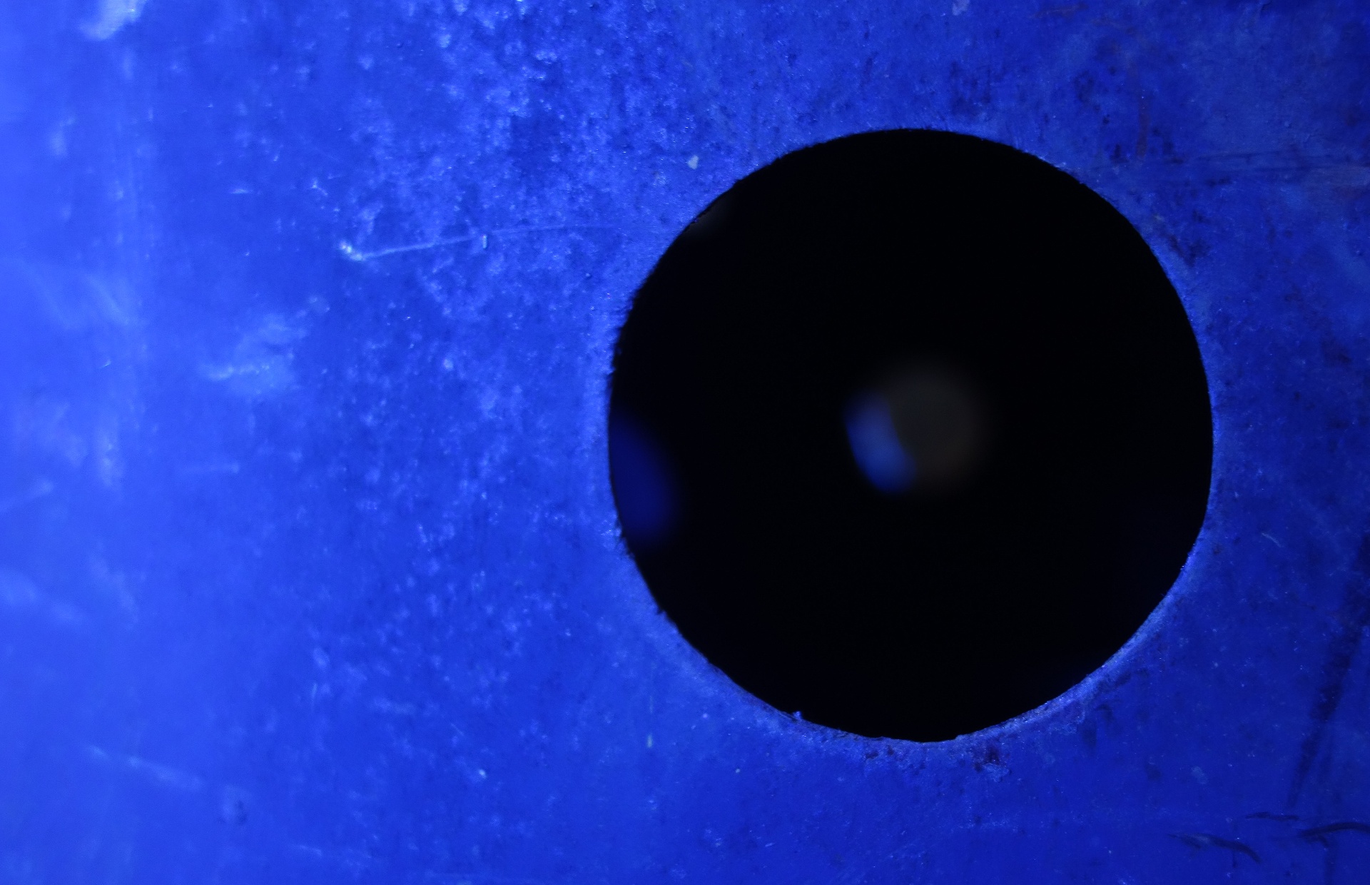 A circular void in a deep blue surface