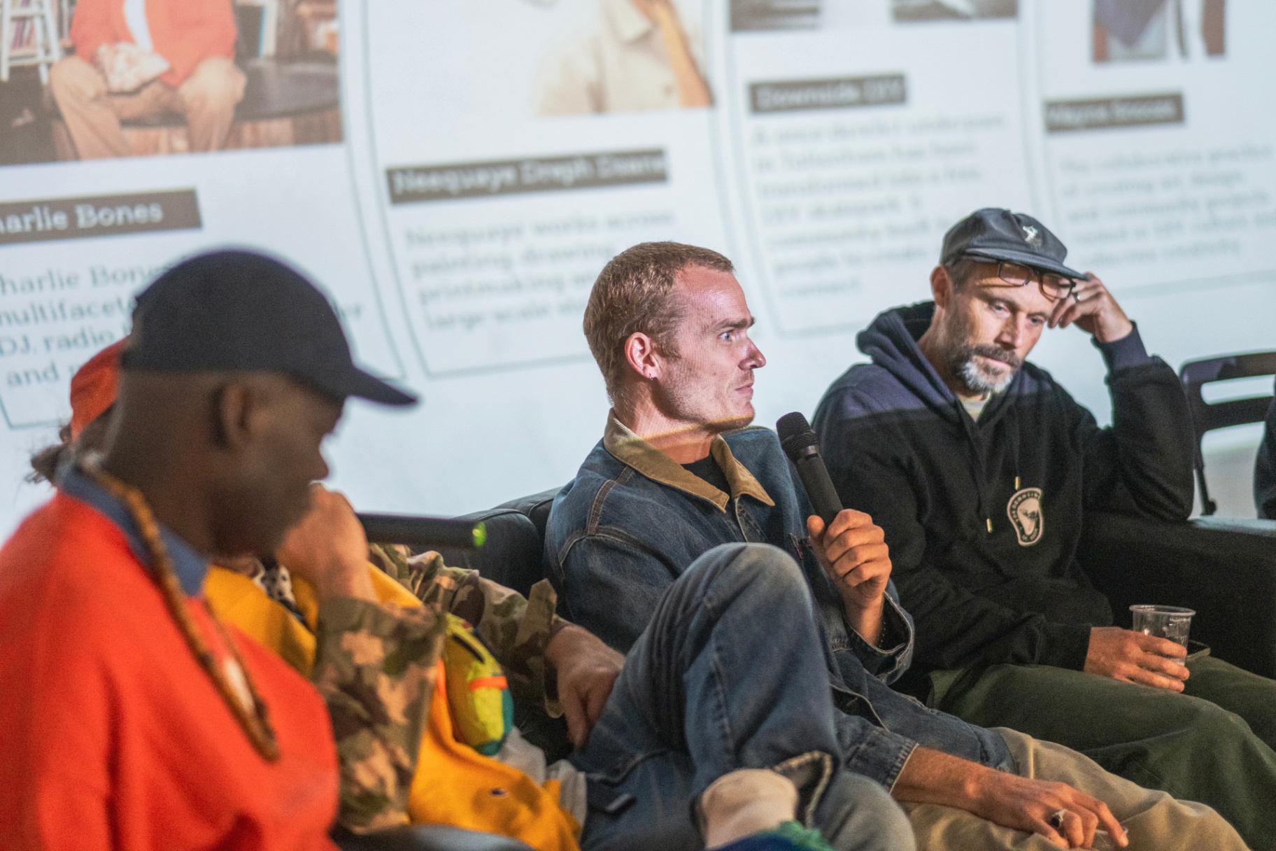 Panellist speaking into a microphone during Creative Resistance.