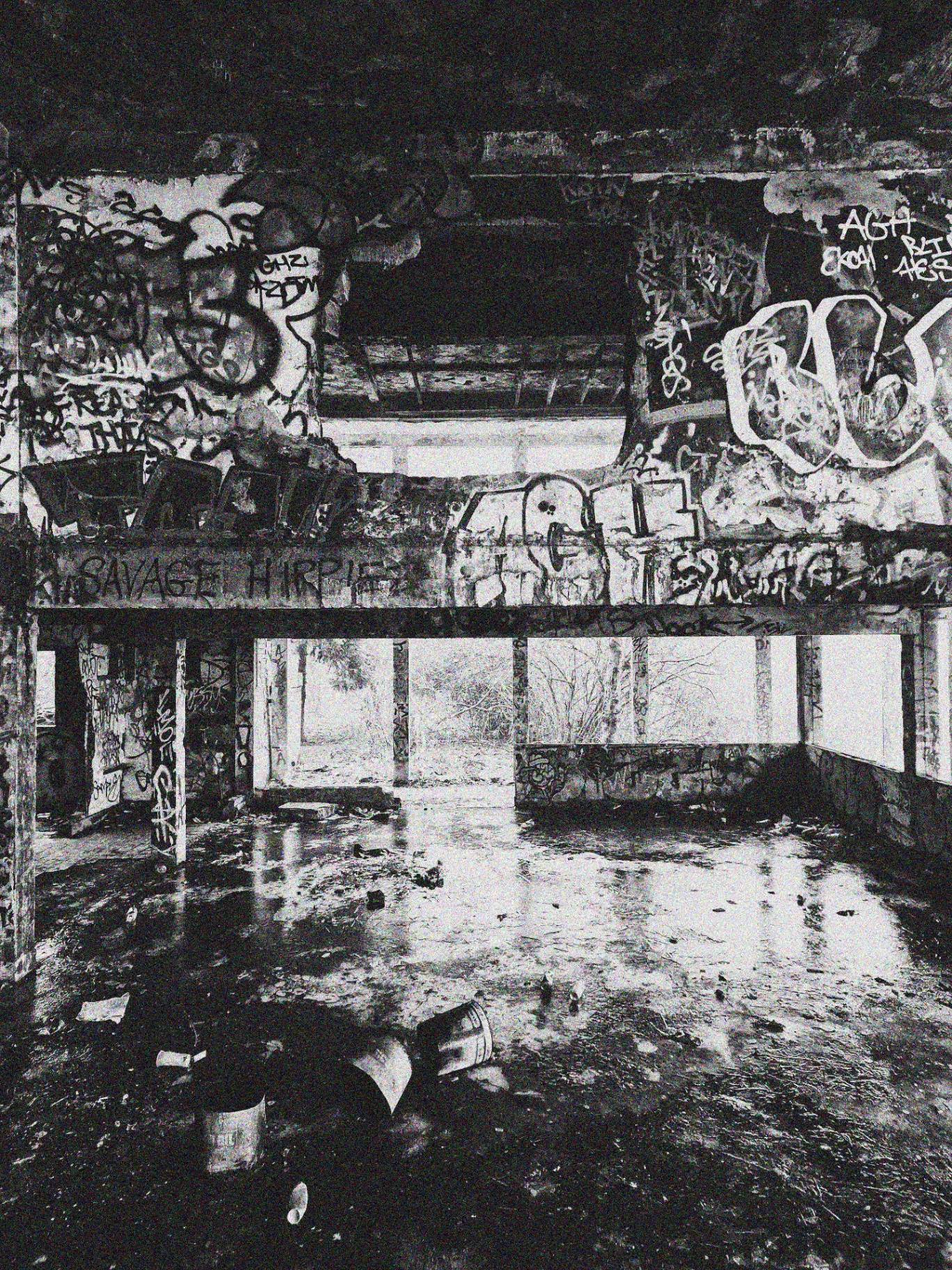 Graffiti-covered interior of an abandoned building.